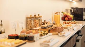 A breakfast buffet with various food items and condiments.