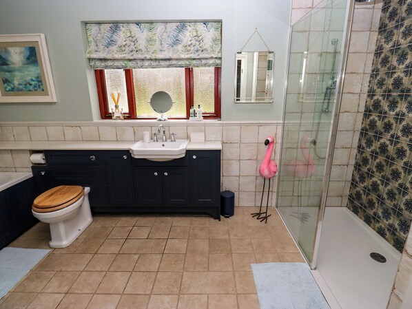 A bathroom with a toilet, sink, and shower.