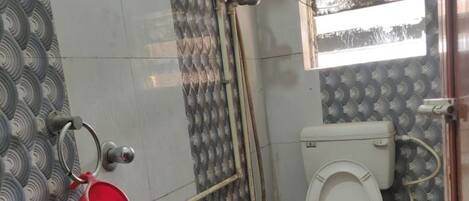 A bathroom with a toilet, sink, and shower.