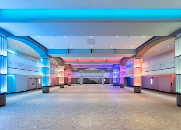 A spacious hotel lobby with a high ceiling, multiple levels, and modern lighting fixtures. - DC Accessible King – Roll-In Shower & Comfort (Washington, DC)