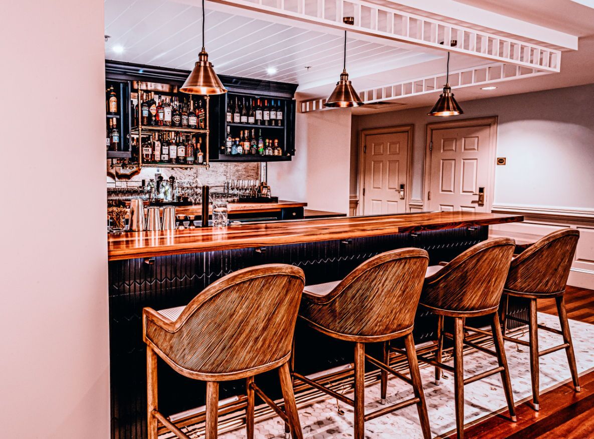 Stylish bar seating and warm lighting set the stage for an intimate evening of fine drinks and conversation.
