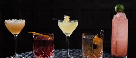 Signature cocktails, expertly crafted, blending bold flavors and artistic presentation for a memorable sip.