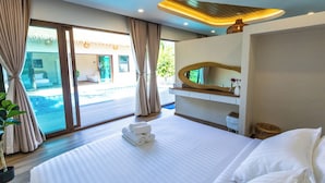 A modern hotel room with a large bed, a view of a pool, and a balcony. - Secret gem Villa Tropical design Private Pool Mountain View (Aonang)