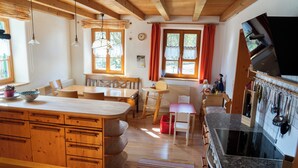 A spacious kitchen with wooden cabinets, a granite countertop, and a built-in stove.