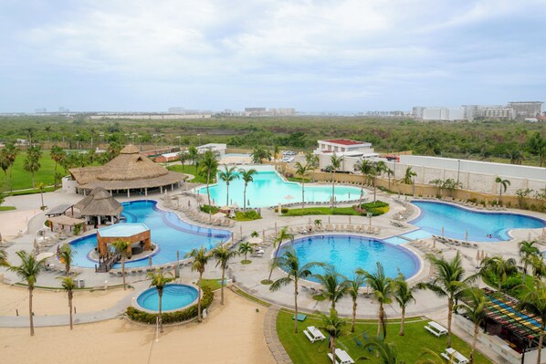 6 outdoor pools, open 8:00 AM to 8:00 PM, pool umbrellas, pool loungers