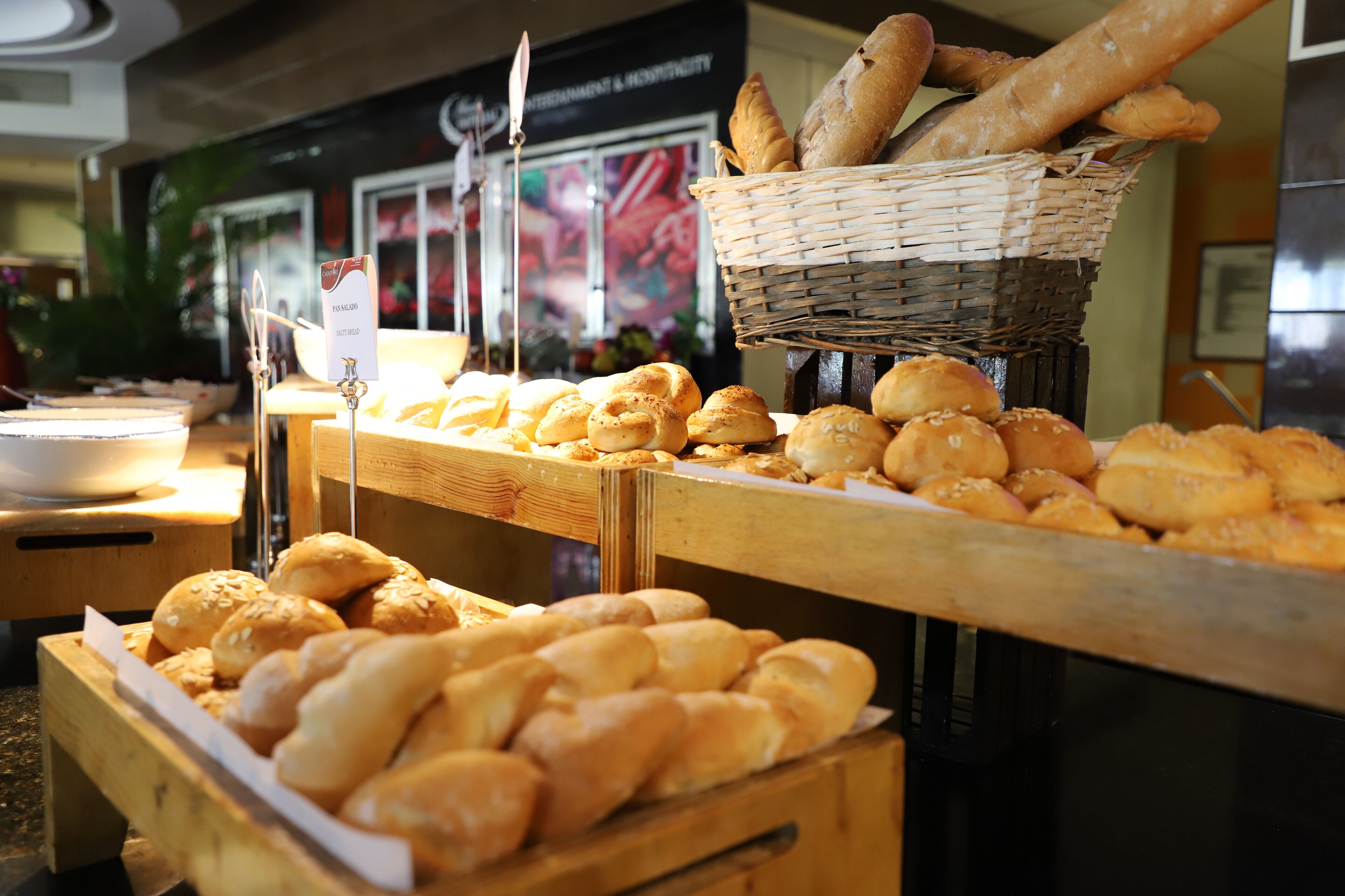 A bakery display with various types of bread and pastries.