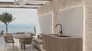 A modern kitchen with a built-in sink and a view of the sea. - Villa Noles (Sukošan)