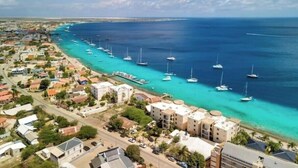 Une ville côtière dotée d’un port de plaisance, de bâtiments le long de la côte et d’eaux d’un bleu limpide.