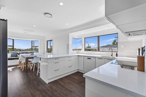 Kjøleskap, oppvaskmaskin, brødrister og høy barnestol