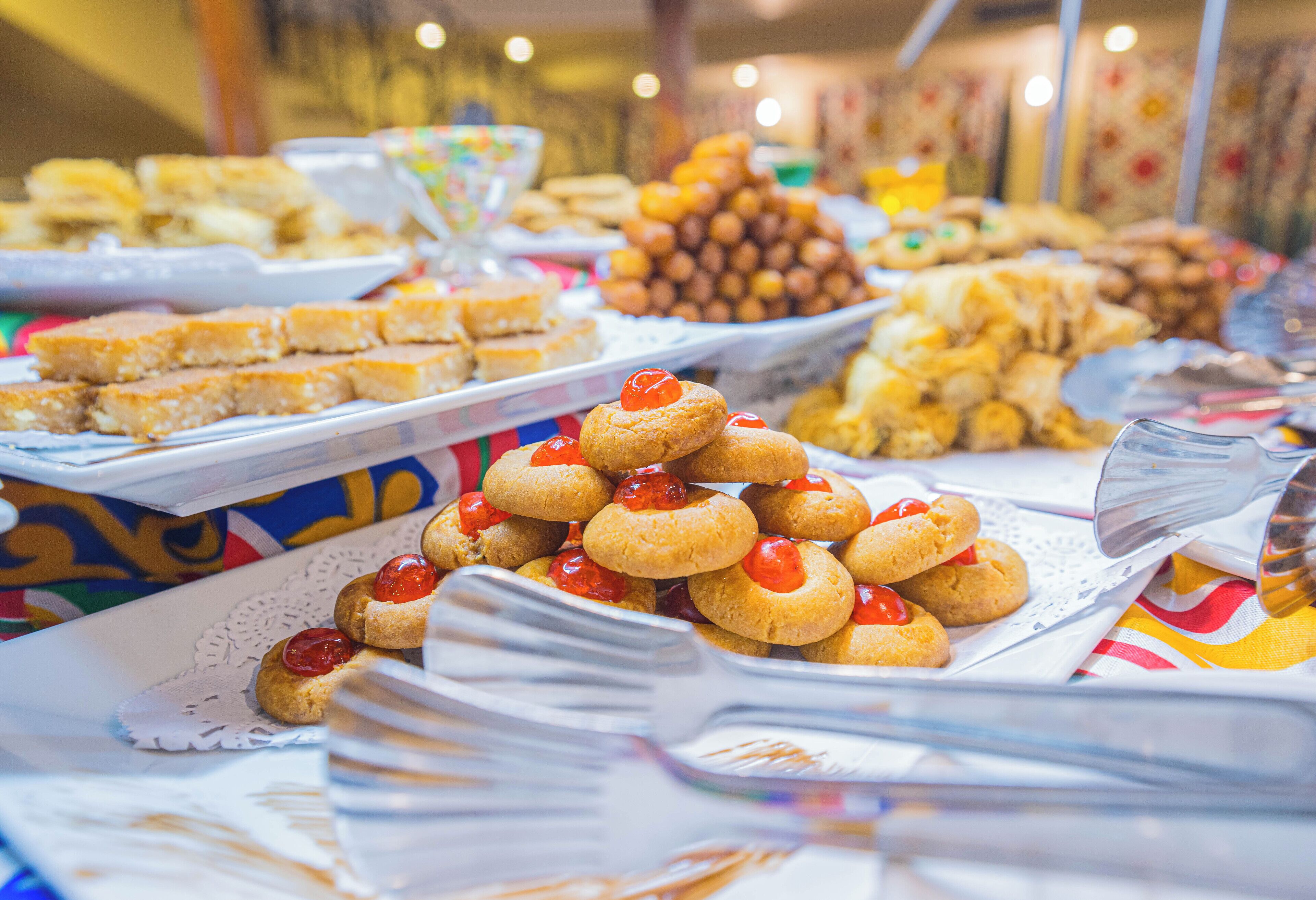 A buffet with various food items including cookies and pastries.