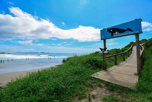 Stroll along the coastal walkway to a whale watching spot, surrounded by lush greenery and the soothing sounds of the ocean.