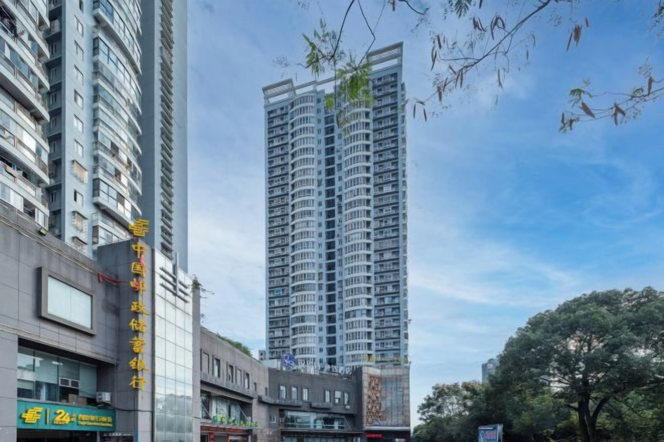 A high-rise building with multiple floors, large windows, and a modern architectural design.