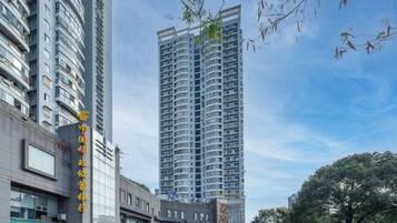 A high-rise building with multiple floors, large windows, and a modern architectural design.