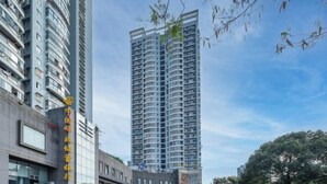 A high-rise building with multiple balconies and a clear sky. - Rest Comfort Hotel (Wenzhou Oubei Shuangta Road) (Yongjia)
