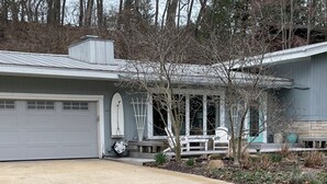 A two-story house with a garage, a covered porch, and a stone foundation. - Classic mid-century Long Beach home with modern updates - Walk to Stop 30 beach! (Long Beach)