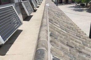 A row of large, cylindrical objects with a textured surface, possibly a part of a building's exterior. - Xinzhuang Seafood Hotel (Zhaoyuan)