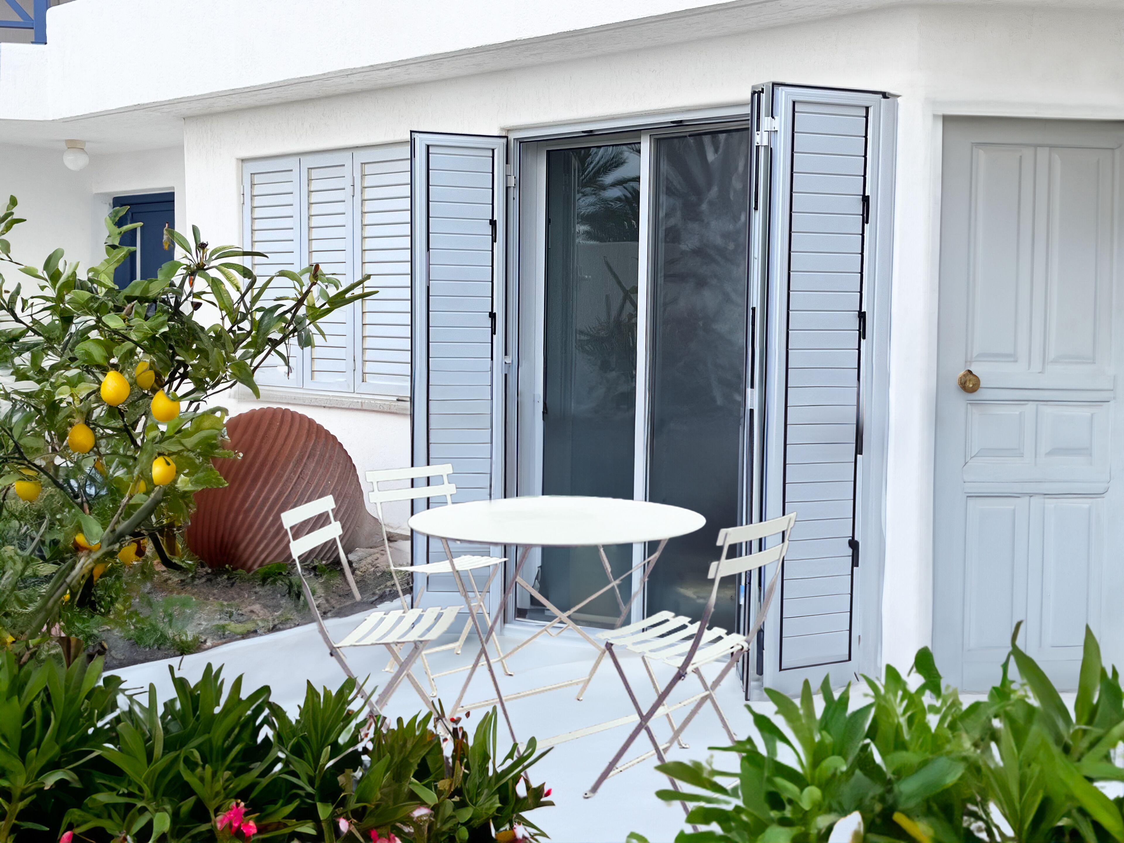 Cozy BBQ terrace under lemon tree—eat, relax, and enjoy the sea breeze.