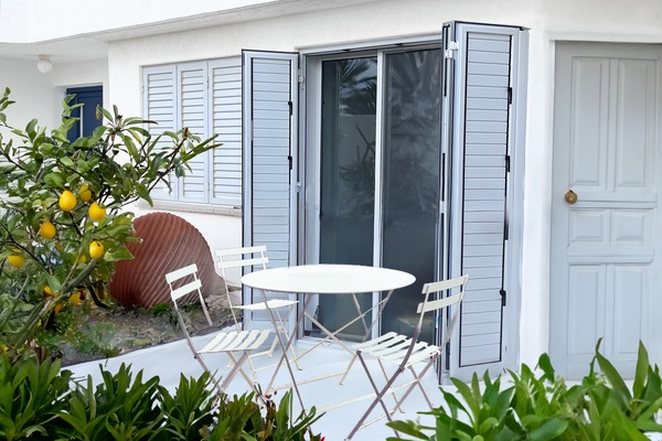 Cozy BBQ terrace under lemon tree—eat, relax, and enjoy the sea breeze.