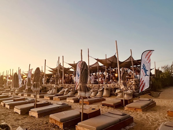 On the beach, sun loungers, beach towels