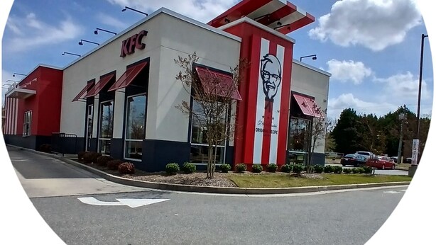 A KFC restaurant with a red and white color scheme, a large logo, and a clear sky in the background. - Entire House Quite Neighborhood (Kannapolis)