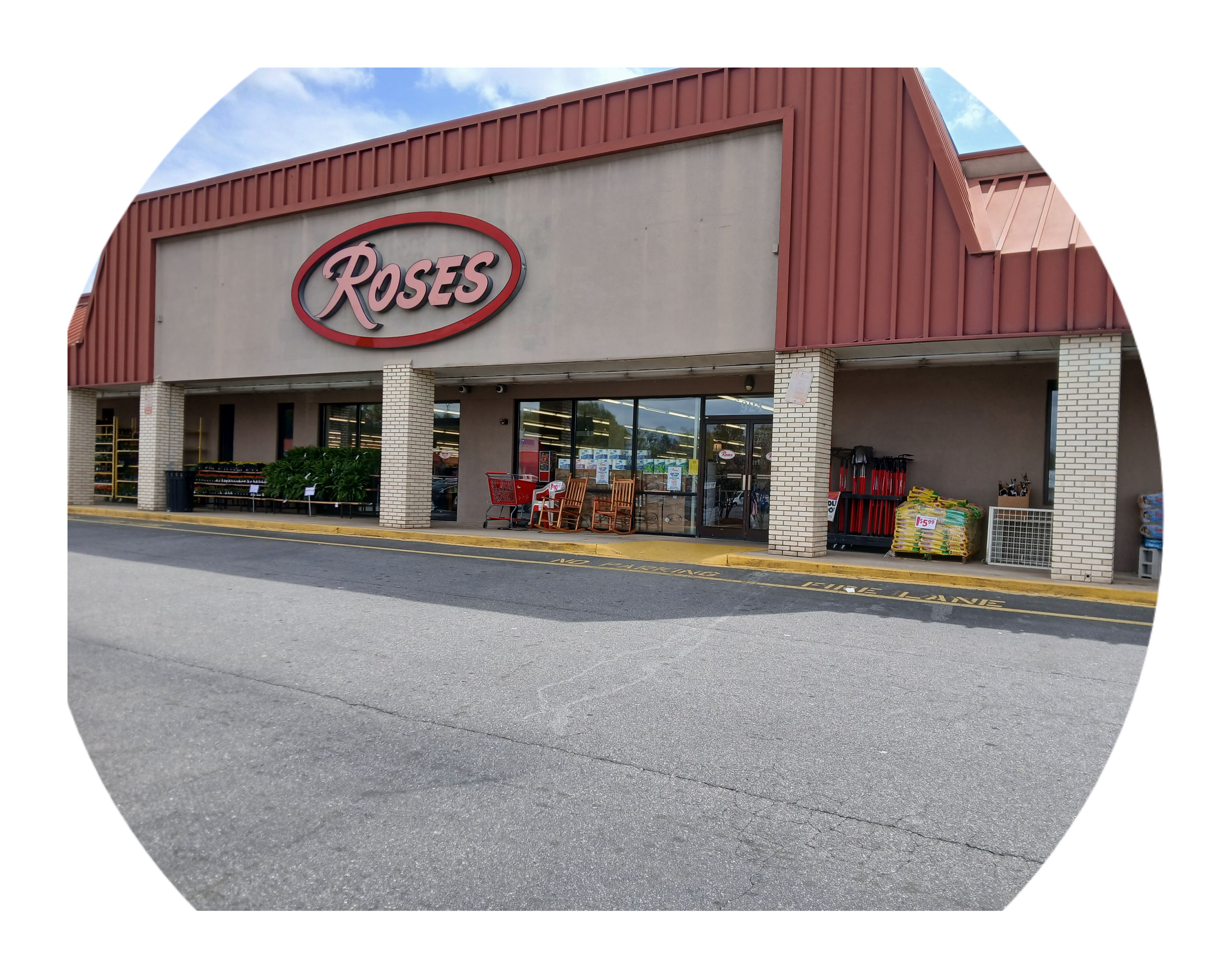A Roses store with a red roof and a large sign.