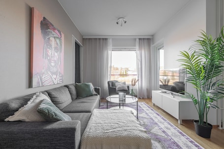 Comfort Apartment, City View | Living area | 50-inch Smart TV with digital channels