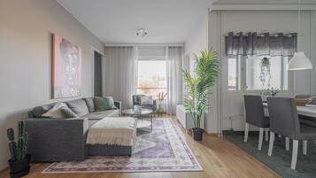 Comfort Apartment, City View | Living area | 50-inch Smart TV with digital channels