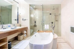 A modern bathroom with a large bathtub, a glass-enclosed shower, and a wooden vanity with a mirror. - Xi'an Zhongxing Hetai Hotel (Xi'an)