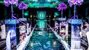 A luxurious hotel lobby with a central water feature, elegant chairs, and purple flowers on tall stands. - Xi'an Zhongxing Hetai Hotel (Xi'an)