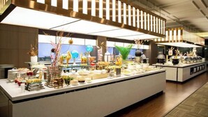 A buffet setup with various food items and decorative elements. - Xi'an Zhongxing Hetai Hotel (Xi'an)