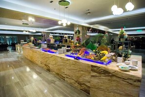 A marble counter with various food items and a decorative plant. - Xi'an Zhongxing Hetai Hotel (Xi'an)