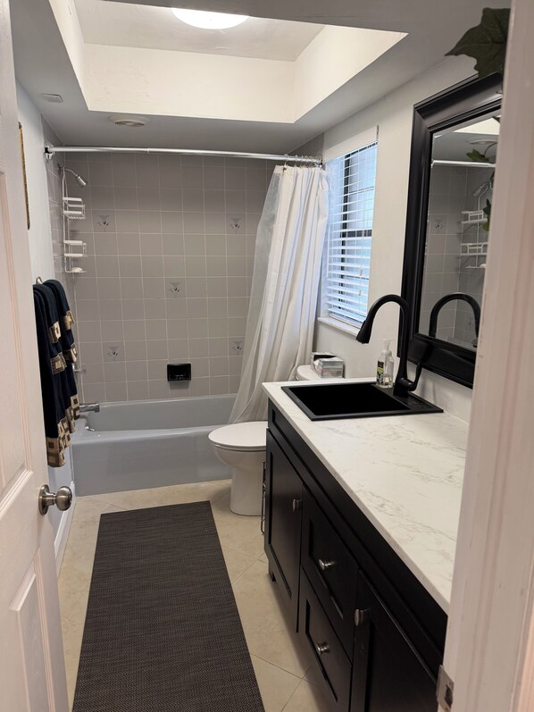 Un baño moderno con bañera, inodoro y lavamanos.