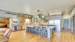 A spacious kitchen with a central island, wooden cabinets, and stainless steel appliances. - Riverside Retreat in Bridgeport w/ Game Room! (Bridgeport)