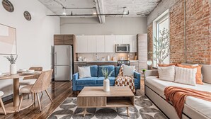 A modern kitchen with white cabinets, a microwave, and a refrigerator. - Downtown Dallas Loft (Dallas)