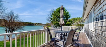 Tranquil waterfront home with stunning views, a spacious deck, and a BBQ grill