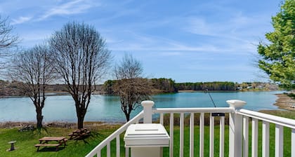 Tranquil waterfront home with stunning views, a spacious deck, and a BBQ grill