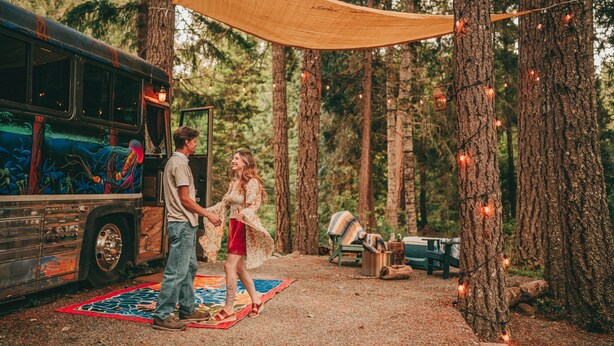 A forest campsite with a bus, a blanket, and a bench. - Madrone Hideout-Artist Bus Retreat at Azalea Grove Getaway (Douglas County)