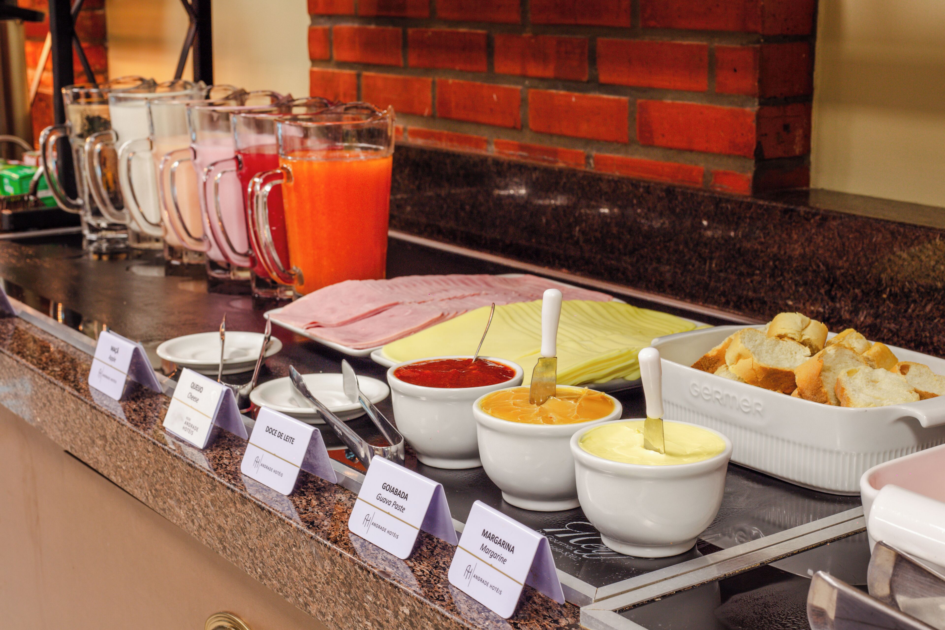 A buffet with various food options and condiments.