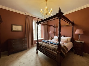 A four-poster bed with a chandelier, a dresser, and a window with curtains. - Monastery 8 - Paterson 2 bedroom apartment with luxury period features (Fort Augustus)