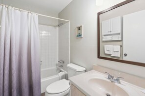 A bathroom with a bathtub, toilet, and sink. - Sea Cloisters 303e (North Myrtle Beach)