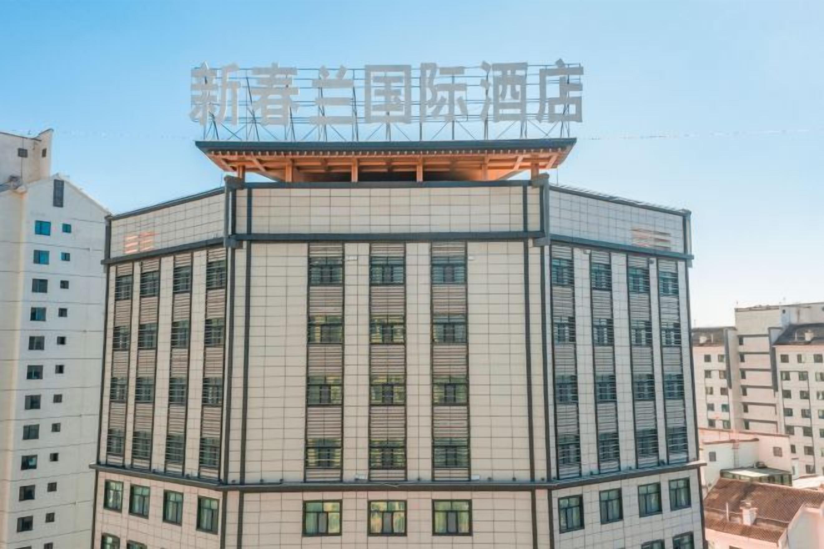 A multi-story building with a prominent sign at the top.