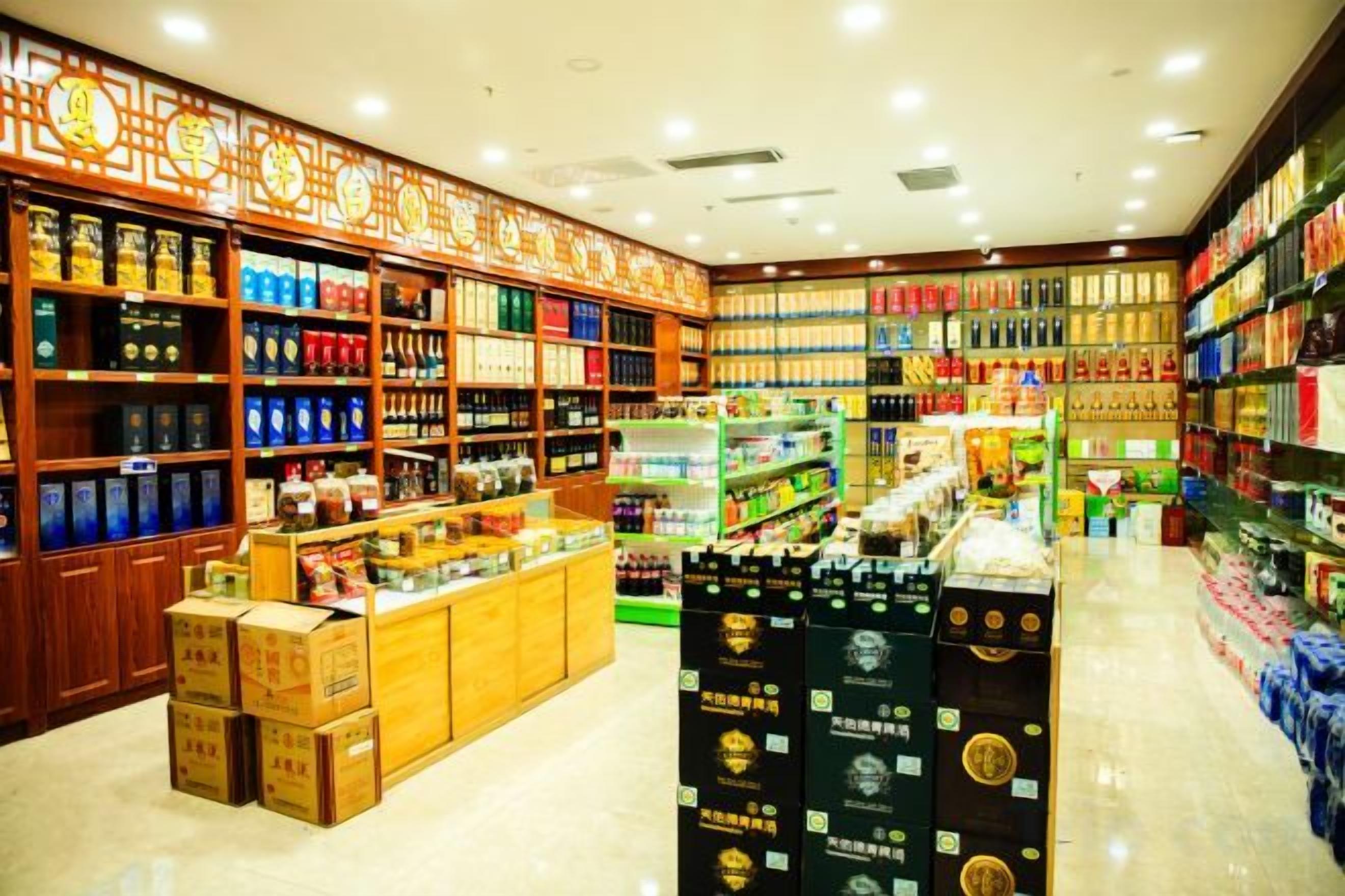 A well-lit store with shelves stocked with various products, including boxes and bottles.