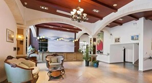 A spacious lobby with a reception desk, seating area, and a large wall mural. - GreenTree Alliance Hotel (Shanghai Baoshan District Meilan Lake Yueluo Road) (Shanghai)