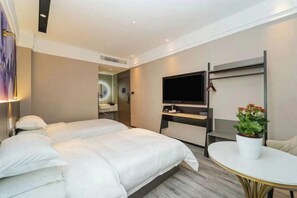 A hotel room with two beds, a TV, a small table, and a potted plant. - Shanghai Evening Fenglin Hotel (Shanghai)
