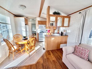 Enjoy a compact living space with a dining area, kitchenette, and cozy seating area.