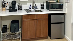 A kitchen with wooden cabinets, a stainless steel refrigerator, a microwave, a coffee maker, and a sink. -  Deluxe Guest Suite with Private Entrance, Near San Diego Beaches, Sleeps 4 (San Diego)