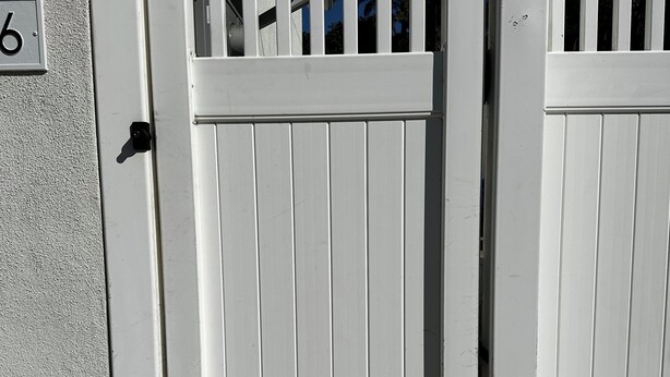A white wooden gate with a number "6" sign on the wall beside it. -  Deluxe Guest Suite with Private Entrance, Near San Diego Beaches, Sleeps 4 (San Diego)