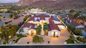 A large, multi-story residential building with a courtyard, surrounded by desert landscape and mountains. - Poolside Oasis, Golf Paradise, Hot Tub, Spa, Views (La Quinta)