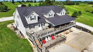 A large house with a covered porch and outdoor seating.