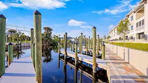 A waterfront dock with wooden posts and a walkway.